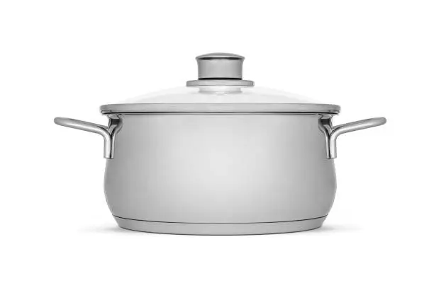 Stainless steel cooking pot with glass lid on white background, including clipping path. Modern kitchen utensils with thick bottom for electric, infrared, induction or gas stoves