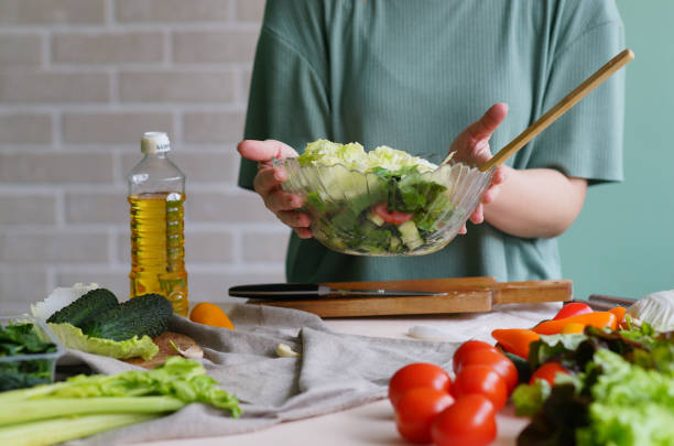 istock Prepare salad. Vegetables background. Kitchen ingredients. Detox 1368431504