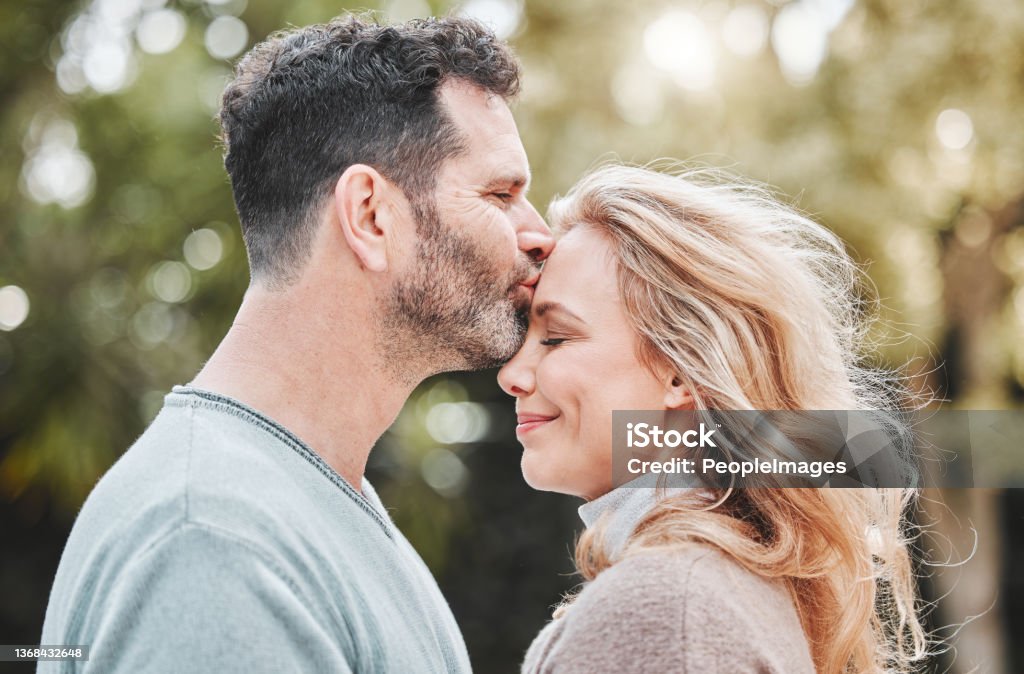 Shot Of An Affectionate Mature Couple Standing Outside Stock Photo -  Download Image Now - iStock