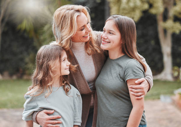 Shot of a woman spending time outdoors with her two daughters