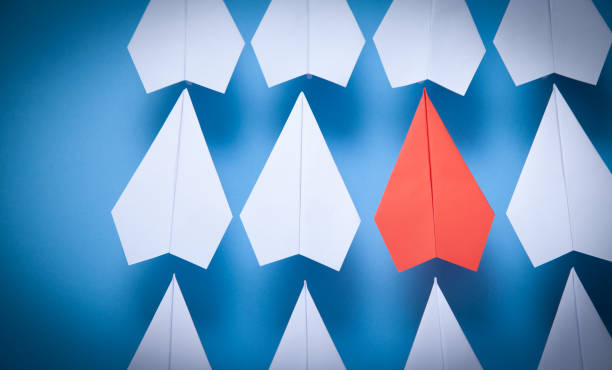 istock Red and white paper airplanes on blue background. Leadership. Teamwork 1368435018