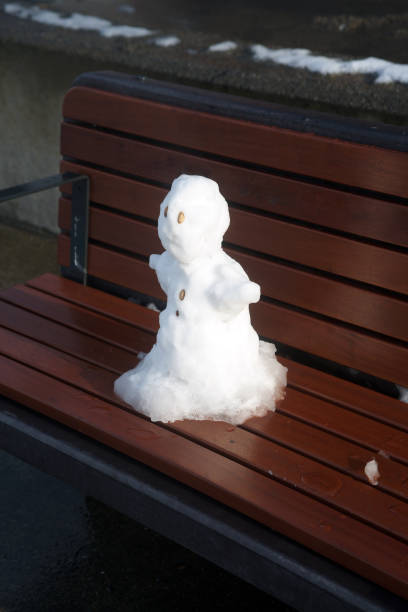 istock snowman on the bench 1368435988
