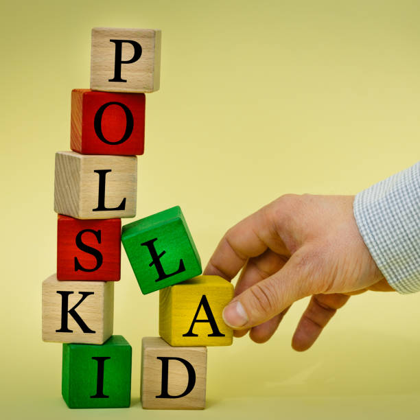 istock Hand pulling out a wooden element from a tower collapsing with an inscription in Polish Polish Lad (Polish Order) Full of mistakes reform of state finances 1368436244