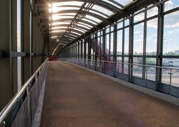 istock long empty road crossing with transparent glass walls 1368438935
