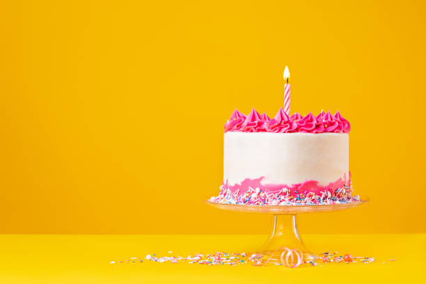 istock Pink Birthday Cake with Candle on Yellow 1368439248