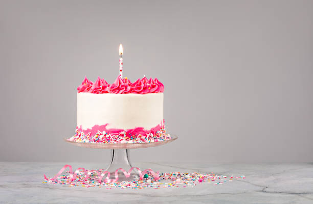 istock Birthday Cake with Pink Icing and Candle 1368439322