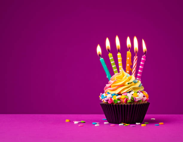 Colorful Birthday Cupcake with Many Candles Rainbow Birthday cupcake with six lit birthday candles and colorful sprinkles over a bright purple background. A fun Birthday party treat. birthday cake green stock pictures, royalty-free photos & images