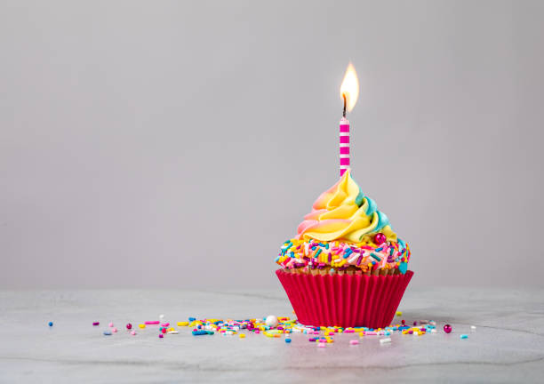 istock Rainbow Birthday Cupcake with Candle 1368439514