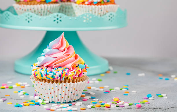 istock Pastel colored Rainbow Birthday Cupcake with sprinkles 1368439546