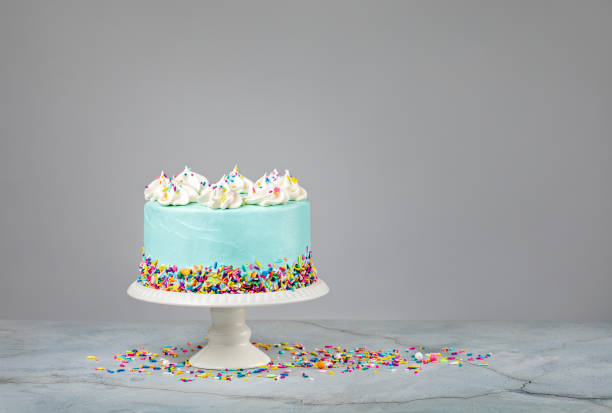istock Blue Birthday Cake with Sprinkles over grey 1368439592
