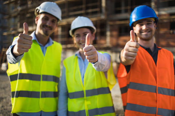 istock Three construction workers having meeting,pose for the photographer 1368440811