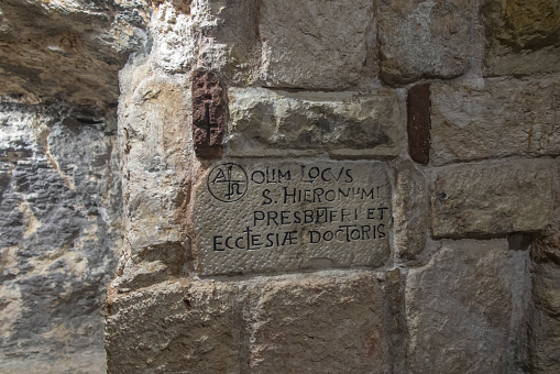 BETHLEHEM, Palestine, January 28, 2020: Caves under the Basilica of the Nativity in Bethlehem. Cross in the grotto of St. Jerome.