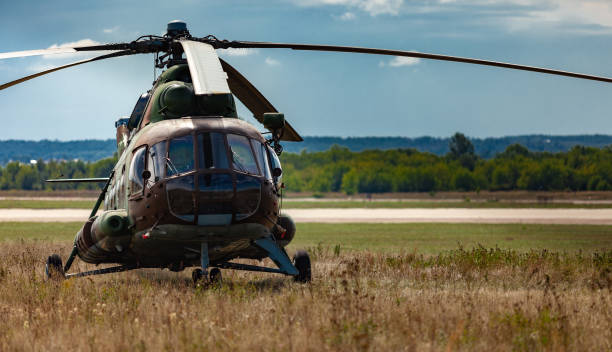 istock helicopter standing in the field under the sun 1368445694