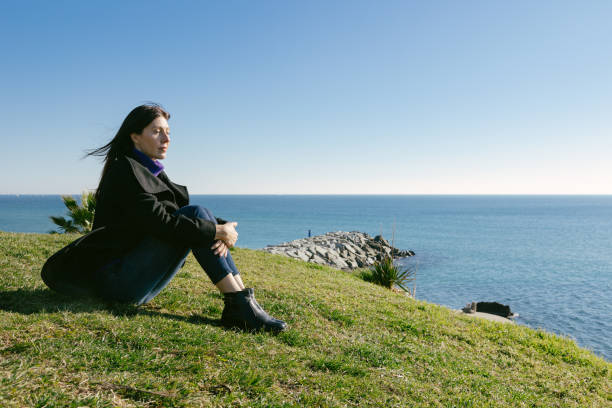 istock Middle-aged woman looking at the sea 1368446994