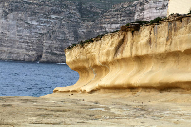 istock Eroded limestone cliffs of Xlendi Bay, Gozo, Malta 1368448563