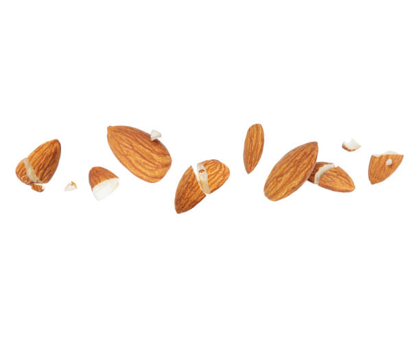 istock Dried almonds crushed in the air on a white background 1368449110