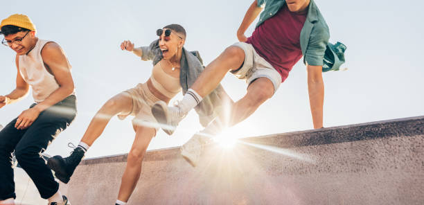istock Energetic friends jumping over a wall outdoors 1368449457