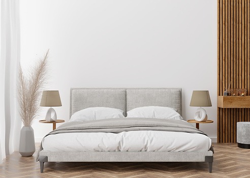 Empty white wall in modern and cozy bedroom. Mock up interior in contemporary style. Free space, copy space for your picture, text, or another design. Bed, lamps, parquet, pampas grass. 3D rendering