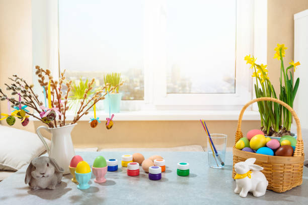 istock festive table decoration for Easter holiday with flowers and eggs. basket full of eggs and rabbit figurine 1368452321