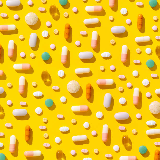 Minimal creative pattern made of pills, drugs and tablets on a modern yellow background. The concept of health and the pharmaceutical industry. Top view. Flat lay.