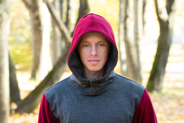 istock Young man walking in autumn park 1368453167