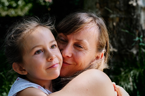 Happiness and joy is the main theme of this summery portrait of mother and her daughter.