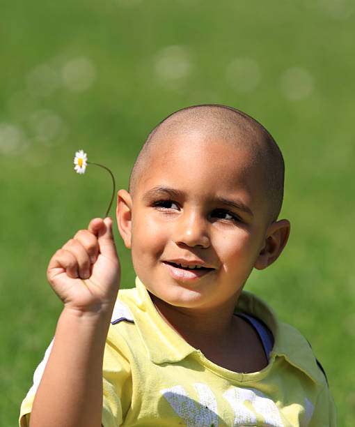 istock Little kid with daisy in hand 136845509