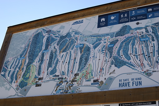 January 29, 2022 - The Blue Mountain, Ontario, Canada: View of the Blue Mountain's ski trails. Busy ski resort in Ontario, Canada. Skiing and snowboarding at the Blue Mountain in January 2022. Winter staycation in Ontario. Winter sports in Canada