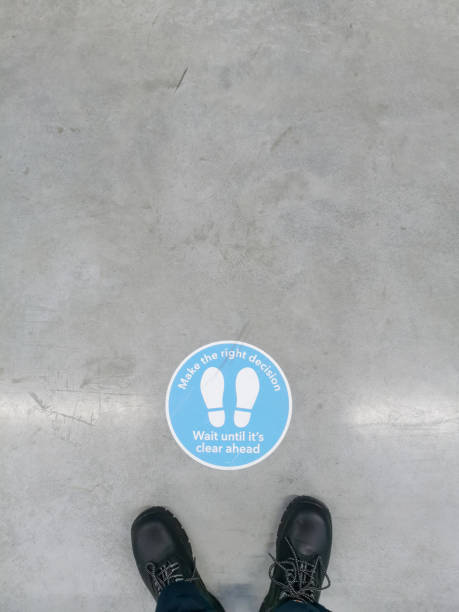 istock Distance Keeping Regulation Signage on Warehouse Floor 1368456066