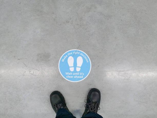 istock Distance Keeping Regulation Signage on Warehouse Floor 1368456070