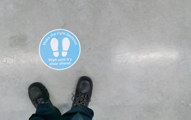 istock Distance Keeping Regulation Signage on Warehouse Floor 1368456073