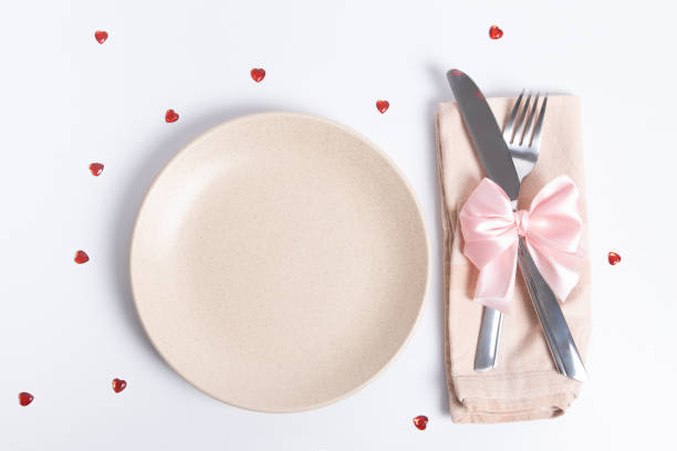 istock Top view cutlery and empty plate on the table. Serving for a romantic dinner on valentines day concept 1368458178