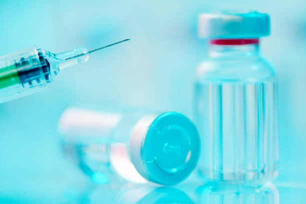 istock Vaccine glass bottle vials and syringe 1368458946