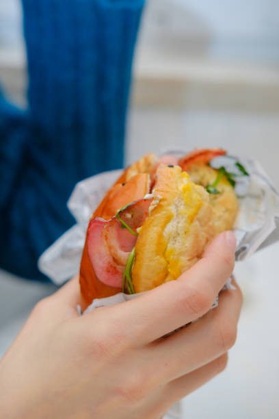 istock hamburger with egg and bacon in a woman's hand 1368458949