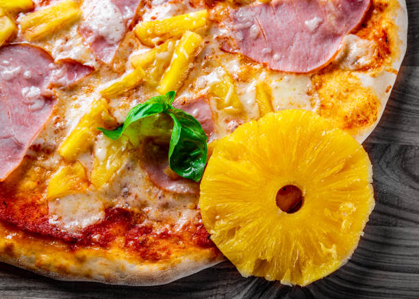 istock fast food. Hawaiian pizza with pineapple, ham, chicken, cheese, and vegetables 1368459084
