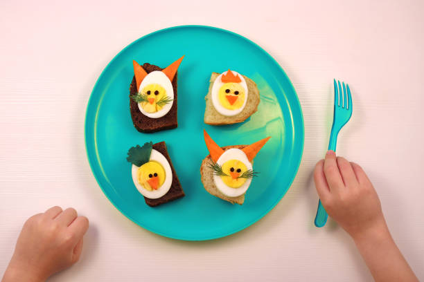 Fun food for kids. Funny egg sandwiches for kids. Rabbit bunny and chicken chick shaped sandwiches. Healthy eating for children. Creative idea for kids breakfast. stock photo