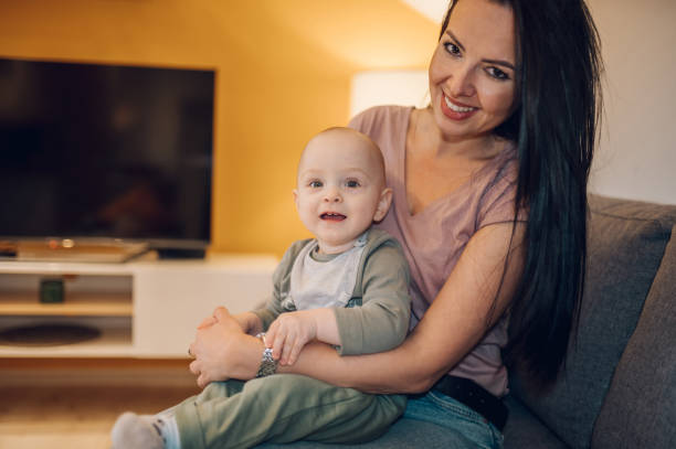 istock Mother and her one year old son playing at home 1368464263
