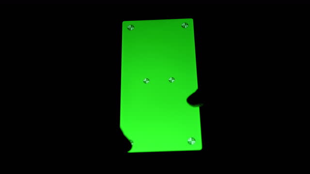 Female Hands Holds a Mobile Phone with a Green Screen in the Dark. 4K. Close up
