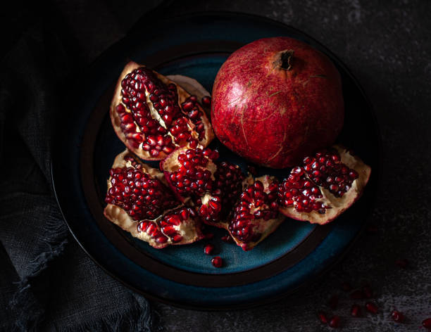 istock Pomegranate on a dark table background. Red, ripe, sweet and delicious 1368465954