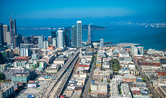 Aerial view of San Francisco road to Bay Bridge and city skyline from helicopter on a clear sunny day