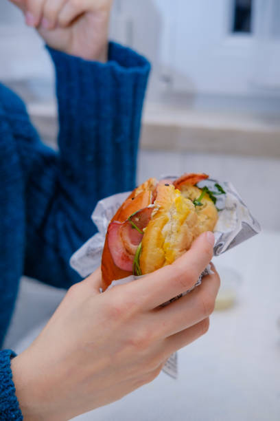 istock burger with egg and bacon in a woman's hand 1368468234