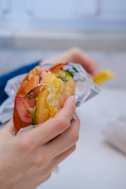istock burger with egg and bacon in a woman's hand 1368468295