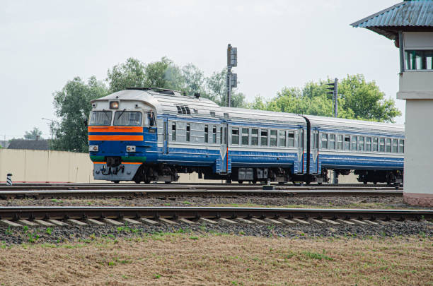 istock Old diesel passenger train rides on rails 1368471583
