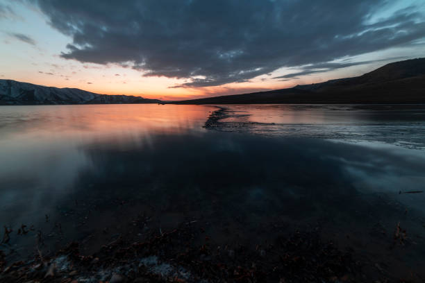 istock Beautiful long exposure landscape. Small lake and mountains after sunset with dramatic clouds. 1368474677
