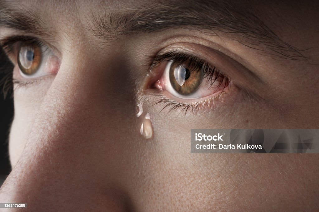 Closeup of young crying man eyes with a tears Closeup of young crying man eyes with a tears. High quality photo Teardrop Stock Photo