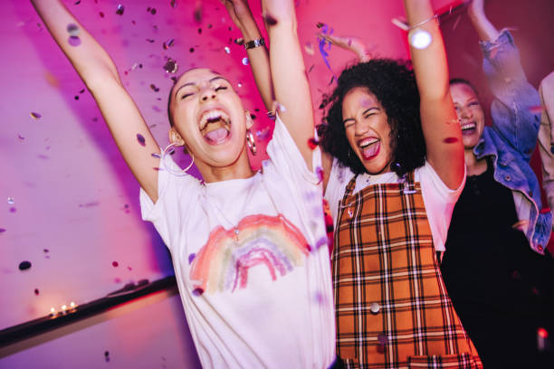 istock Friends cheering happily at a house party 1368476379