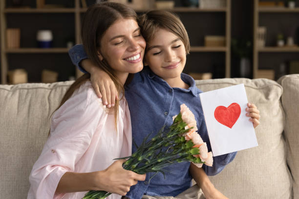 istock Happy loving son kid giving hug with closed eyes 1368476440