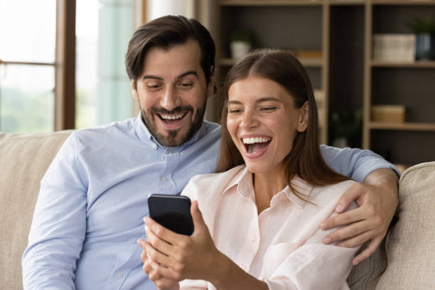 istock Happy excited young couple staring at smartphone screen 1368476588