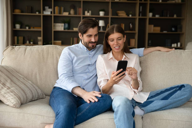 istock Happy millennial couple using online shopping app 1368476872