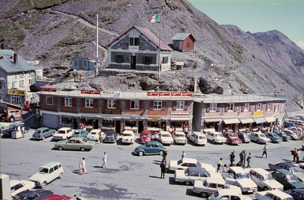Italy (unfortunately no exact location known), 1979. Former border Alpine pass with souvenir shops. Also: tourists, travelers and vehicles.